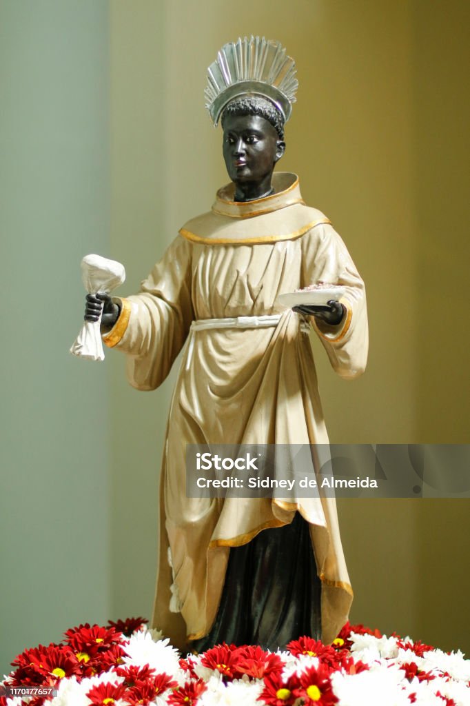 Statue with image of Saint Benedict Statue with image of St. Benedict on altar decorated with flowers, OFM Cap, Order of Friars Minor Capuchin (Ordo Fratrum Minorum Capuccinorum) St. Benedict of Nursia Stock Photo