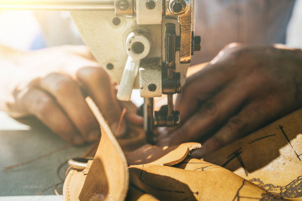 istock Working process of leather craftsman. Tanner or skinner sews leather on a special sewing machine, close up 1170177923