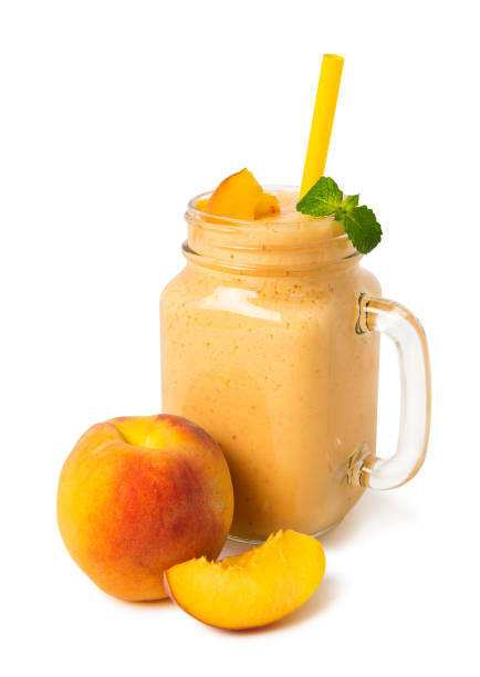 istock Peach smoothies in a glass jar with fresh fruits on a white background 1170179331
