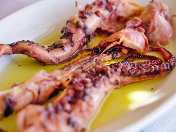 istock Boiled octopus served with oil in white plate. 1170181105