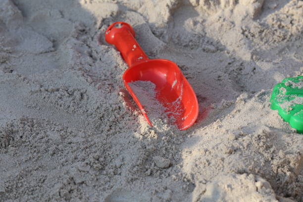 istock Bright childrens toys lie in the sandbox 1170183492