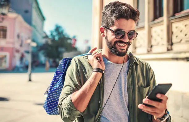 Photo of Modern young man enjoying in shopping. Consumerism, lifestyle concept