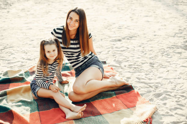 istock Mother with daughter playing in a summer park 1170188664