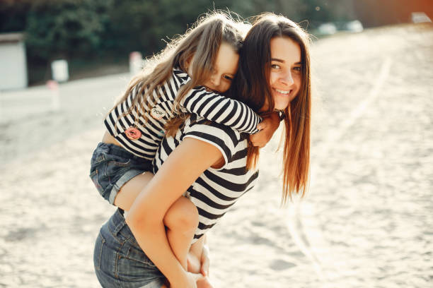 istock Mother with daughter playing in a summer park 1170188711
