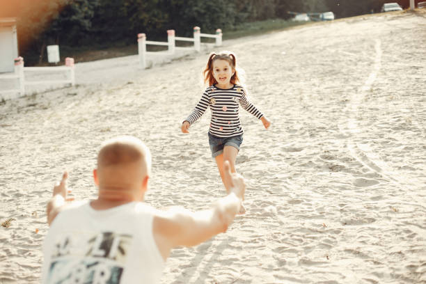 istock Father with daughter playing in a summer park 1170188738