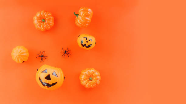 istock halloween background orange decorated holidays festive concept / spider and jack o lantern pumpkin halloween decorations for party accessories object 1170191322