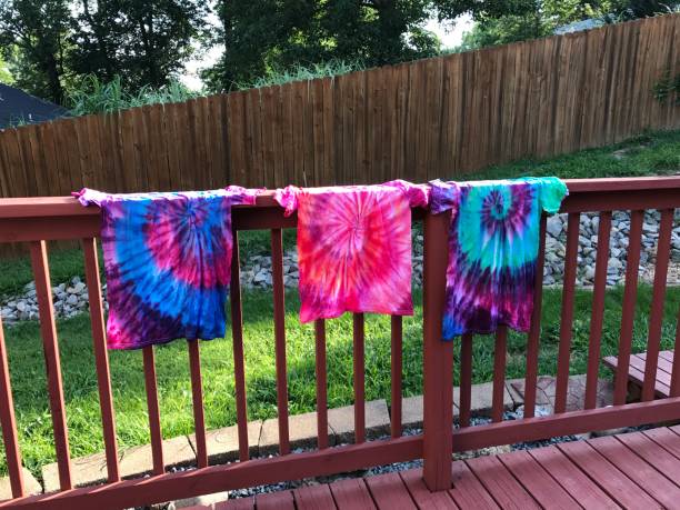 Tie dyed shirts hanging on the rail