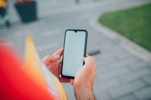 istock Man using navigation app on the smartphone on street 1170193182