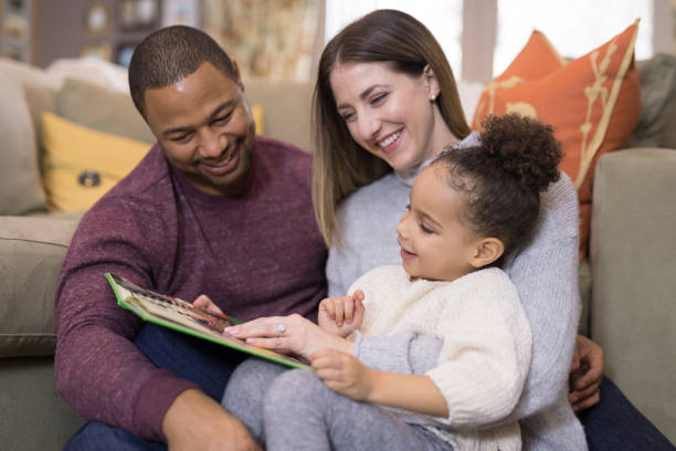 istock Mixed race family reading a book together 1170196140
