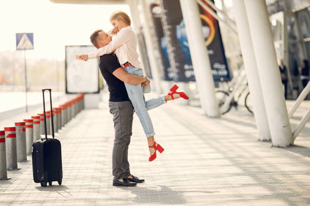 istock Beautiful couple standing in a airport 1170198013