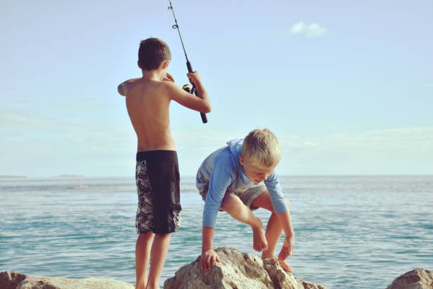 istock Brothers Fishing on Coastal Rocks 1170198192