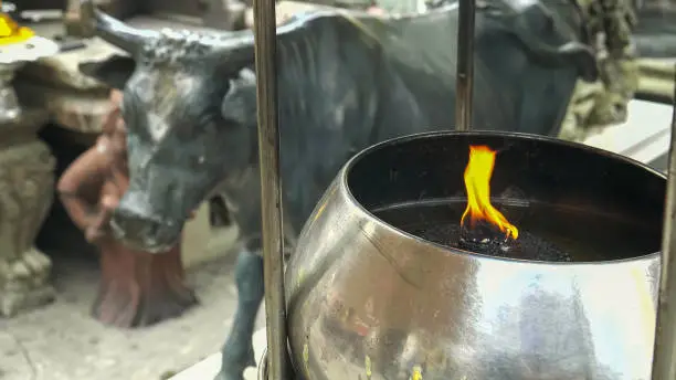 Photo of close up of a flame at wat phra kaew temple in bangkok