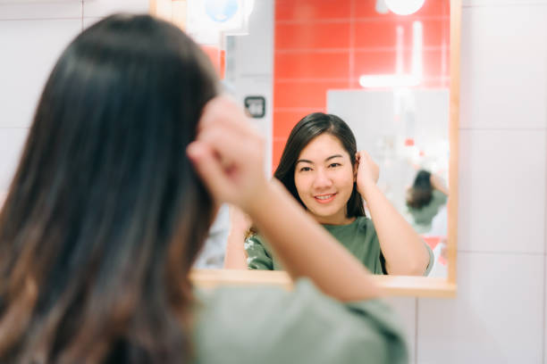 istock Asian women are looking herself reflection in mirror 1170200204
