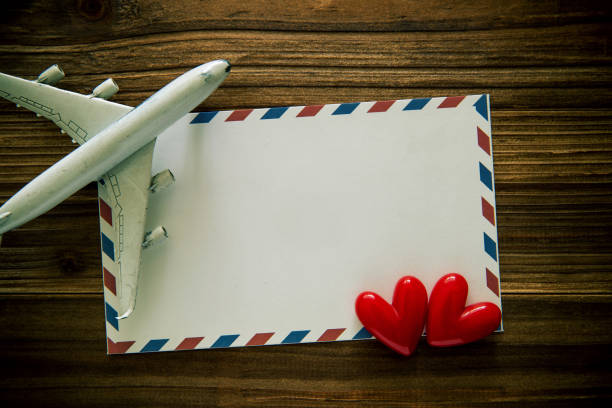 istock (Travel concept) Air mail envelope，model plane and heart shape on wood background 1170205045