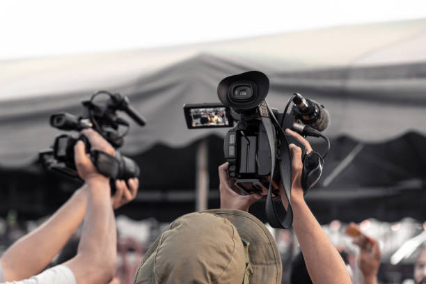 istock Covering event with a professional video camera. Videographer working with equipment. 1170219187