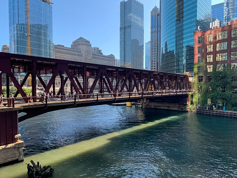Chicago, IL / USA - 7/12/19: Colorful morning in Chicago Loop where summer light displays patterns from cityscape on Chicago River and bridge structure during morning