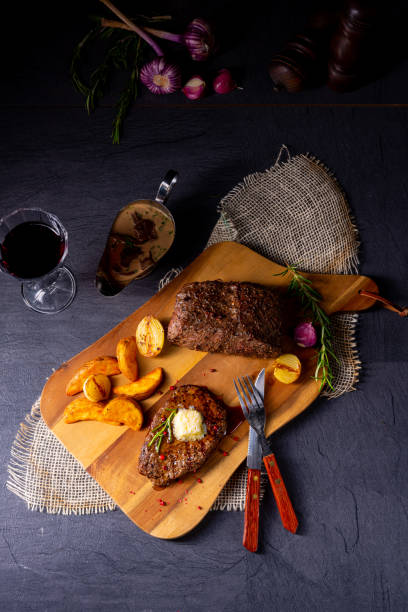istock Butter Beef Steak with herbs and potato wedges 1170221131