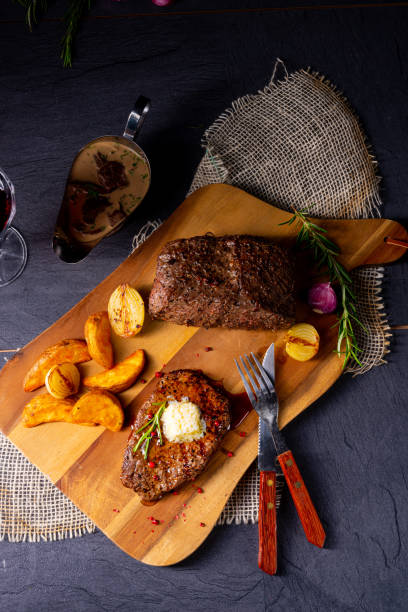 istock Butter Beef Steak with herbs and potato wedges 1170221151
