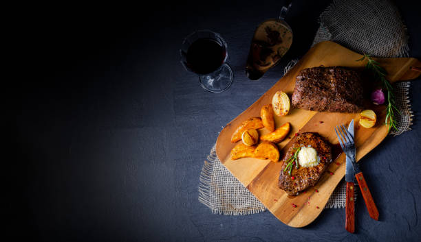 istock Butter Beef Steak with herbs and potato wedges 1170221188