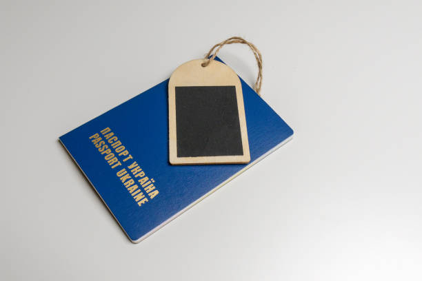 istock Wooden tag with a blue passport on a white table, mockup 1170222262