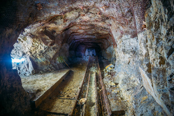 istock Dark dirty abandoned uranium mine with rusty remnants of railway 1170224227