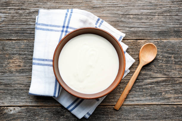 istock Greek yogurt in a bowl on wooden table 1170224316
