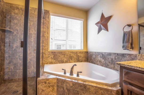 istock Bathroom interior with built in bathtub shower stall and marble tile wall 1170226322