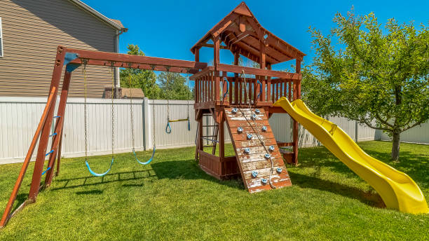 istock Panorama frame Wooden playground structure with yellow plastic slide swings and climbing wall 1170227643