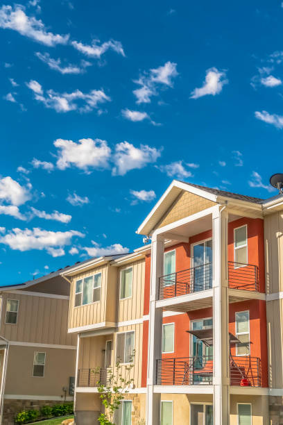 istock Multi storey home exterior with sunlit balconies and white and orange wall 1170228852
