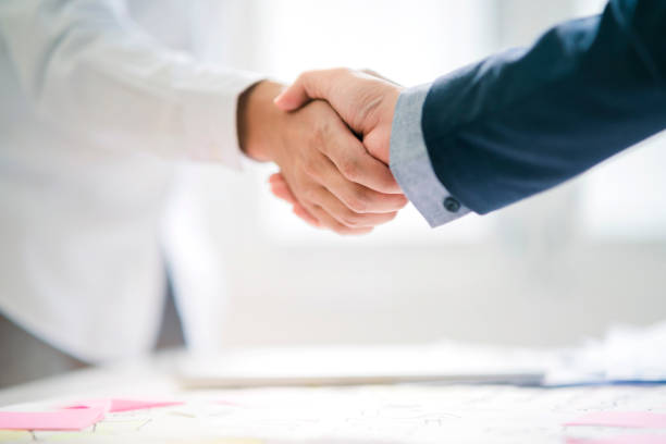 istock business successful contract agreement two businessman handshake with confident and powerful mission achievement white background 1170228886