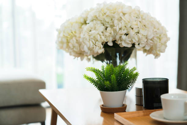 istock Home interior Design Decoration white flower vase on attended coffee table white curtain background 1170228916