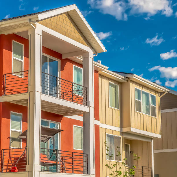 istock Square Facade of multi storey homes with orange and white exterior wall sections 1170229967