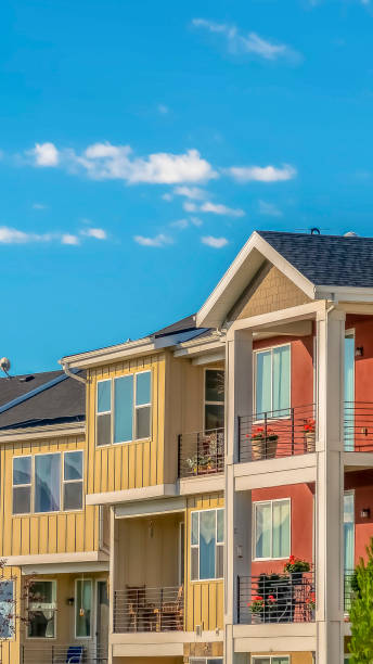 istock Vertical frame Lovely townhomes viewed against blue sky background on a sunny day 1170229984