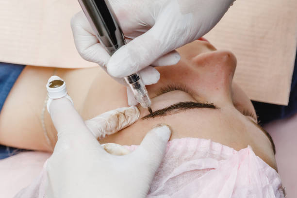 istock Permanent makeup, tattooing of eyebrows. Cosmetologist applying make up 1170231010