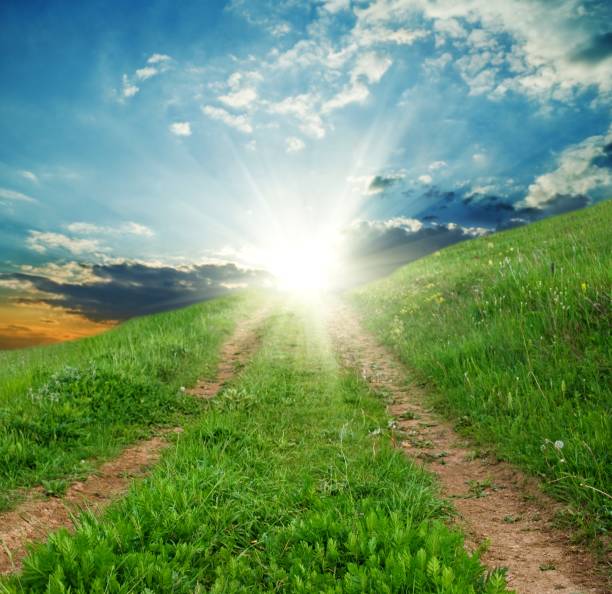 istock road in a hills to a sun 1170231146