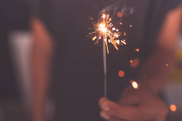 istock young girl burning sparkler in hand 1170231209