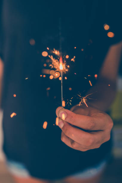 istock young girl burning sparkler in hand 1170231250