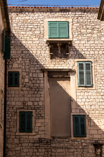 istock Stone house with green closed shutters 1170233012