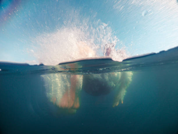 istock man jumping in blue clear water 1170236116