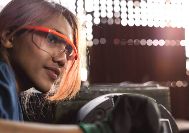 Female Asian engineer working in a manufacturing workshop stock photo
