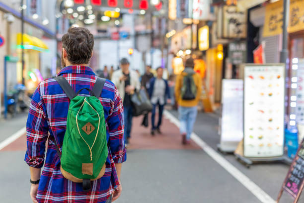 istock Male Backpacker Walking in Tokyo 1170238928