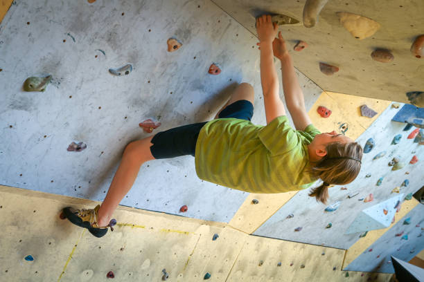 istock Teenage Boy Training Climbing On Indoor Climbing Wall 1170239139