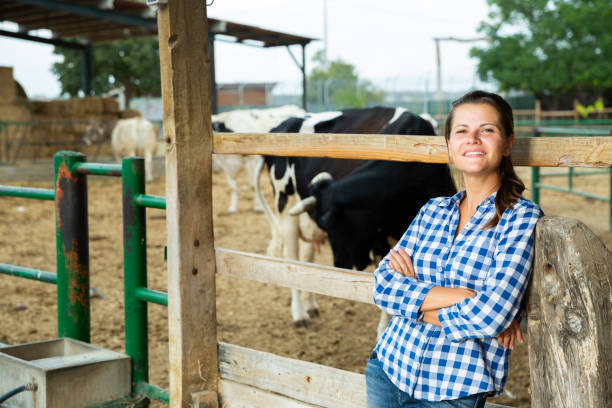 istock Smiling female farmer standing near cowshed 1170240048