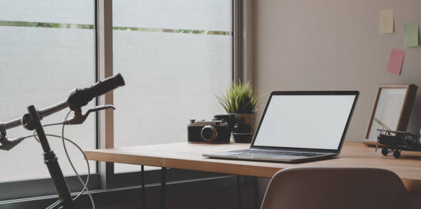 istock Laptop computer in minimal photographer's workplace 1170240247