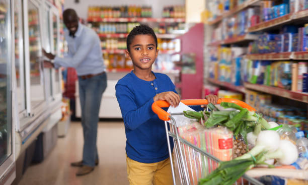 istock Glad African American boy carrying purchases 1170240273