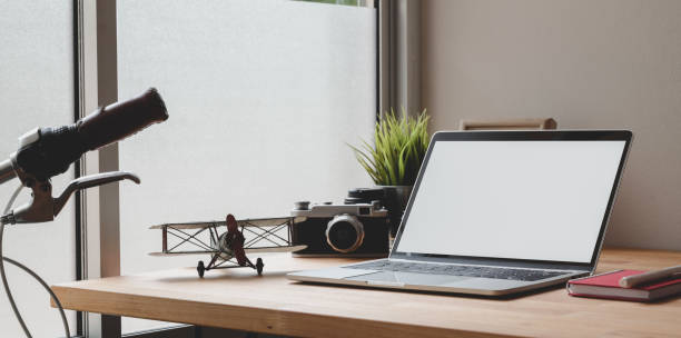 istock Cozy photographer home-office with open blank screen laptop 1170240298
