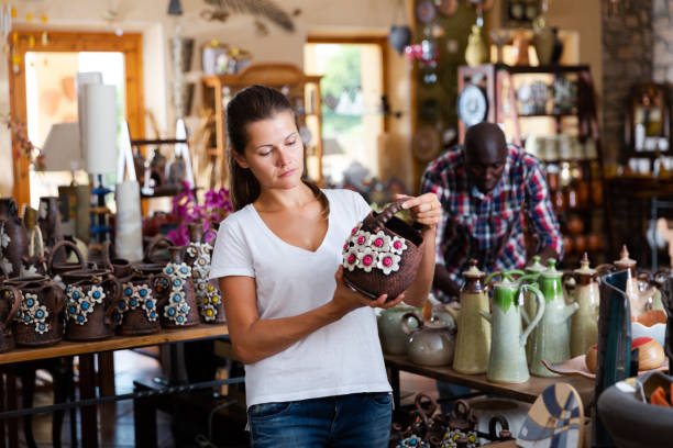 istock Portrait cheerful customer picking glazed crockery in ceramics workshop 1170241156