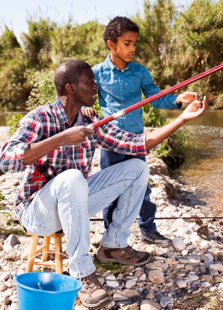 istock Man and his son fishing 1170241287