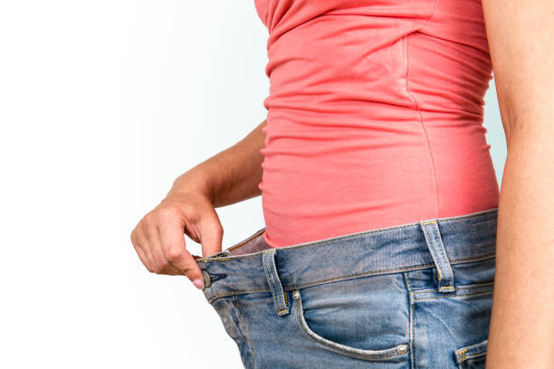 istock Women shows her weight loss 1170241347