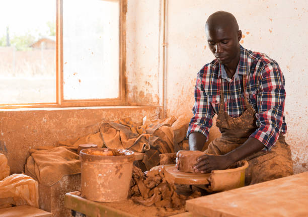 istock Craftsman woring with clay on potter wheel 1170241416